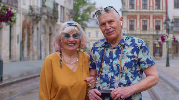 Elderly Stylish Couple Tourists Man and Woman Enjoying Conversation on Street in City Lviv Ukraine