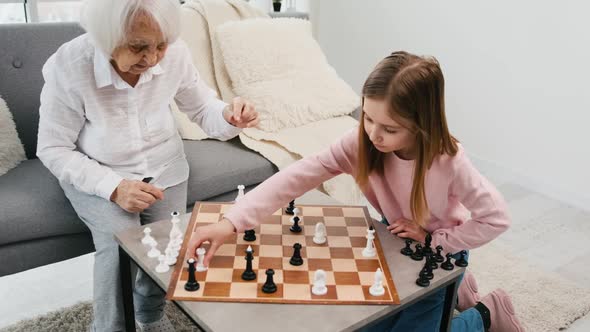 Grandmother Playing Chess with Granddaughter