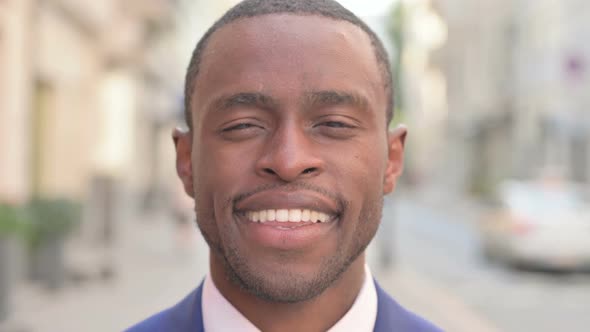 Outdoor Close Up of Smiling African Businessman