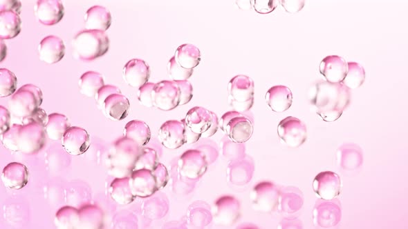 Super Slow Motion Shot of Pink Hydrogel Balls Bouncing on Glass at 1000Fps