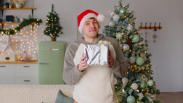 A Young Man is Holding a Wrapped Gift