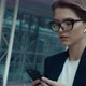 Closeup of Attractive young Businesswoman working on Smartphone while walking. - VideoHive Item for Sale