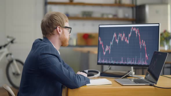 Upset Trader Worried About Financial Loss in Stock Market Sitting at Home Office