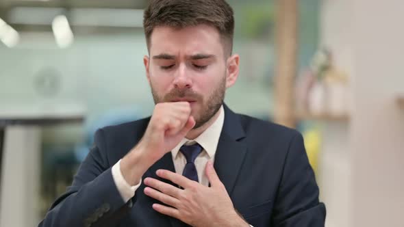 Sick Young Businessman Coughing