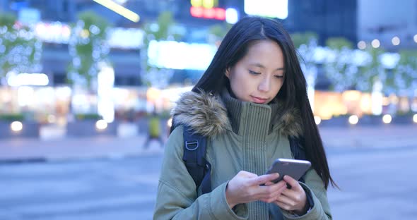 Woman Using Smart Phone at Night