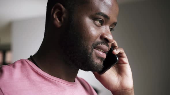 Man drinking tea and talking by phone