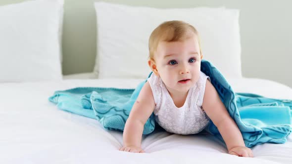 Cute smiling baby girl on bed