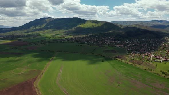 Aerial Video of Fast Moving Clouds Over Green Fields