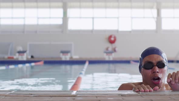 Swimmer coming out of water and looking at camera