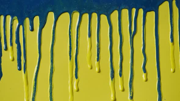 Blue Paint Background Color Tint Drops on Yellow Wall Closeup