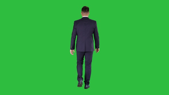 Confident businessman walking on a Green Screen, Chroma Key