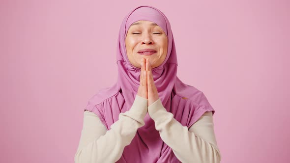 Emotional Islamic Lady in Headscarf Making with Waiting and Enjoying Success Pink Background