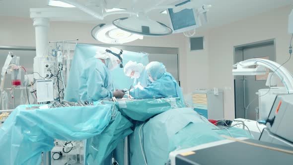 Surgery Room with a Team of Doctors Operating a Patient