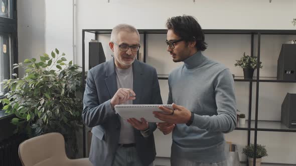 Men Looking at Notebook