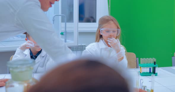 Teacher and Children in Chemistry Class