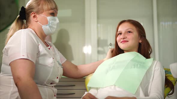 The Doctor the Dentist Discusses with the Teenager a Way of Cleaning a Teeth