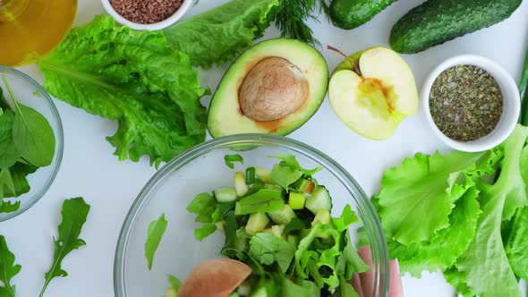 Woman Mix Salad of Fresh Green Vegetables and Herbs