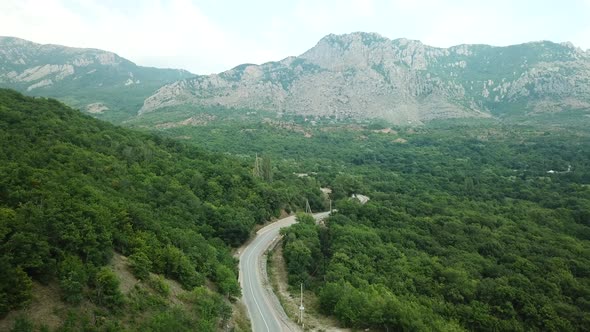 A Winding Road Through the Crimean Mountains Along the Sea