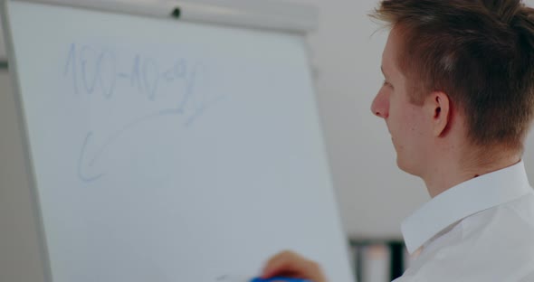 Businessman Writing on Clipboard on Business Meeting