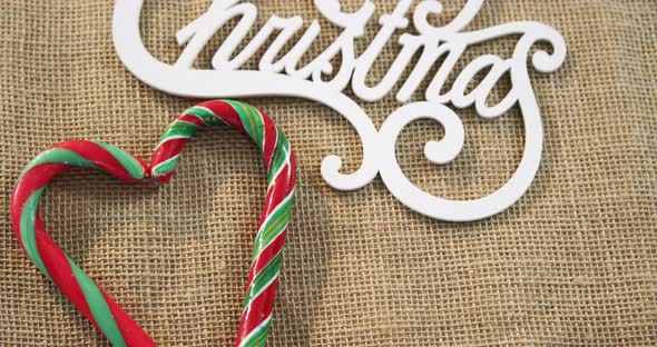 Candy cane with christmas decoration arranged on textile 4k