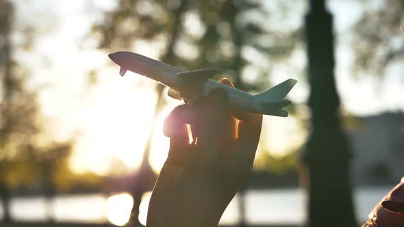 Girl Simulates Take-off of Toy Plane, Slow Motion