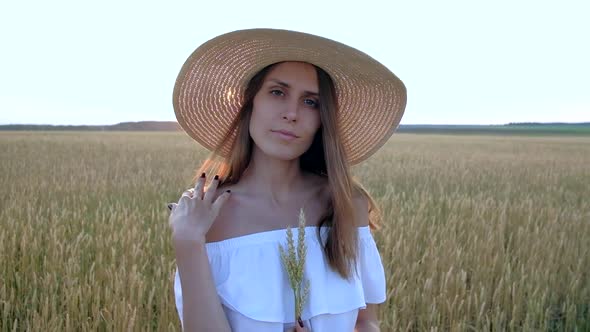 Amazing Portrait of Beautiful Woman Standing in Field of Ripe Golden Wheat