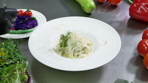 Chef Decorates the Pasta with a Beautiful Flower Before Serving