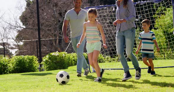 Happy family playing football