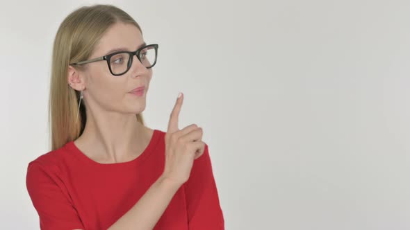 Young Woman Pointing on Side on White Background