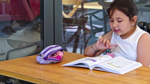 Girl Doing School Homework Outside During Summer Season 2