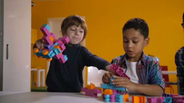 Two Diverse Kids Arguing Over Toy in Kindergarten
