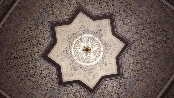 The ceiling is in a traditional oriental style with many details