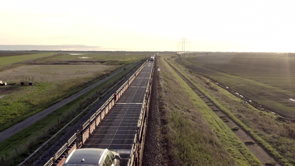 Moto Rail Train Carrying Vehicles and Passengers on a Journey