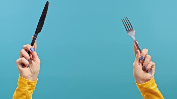 Hands of Woman with Fork and Knife