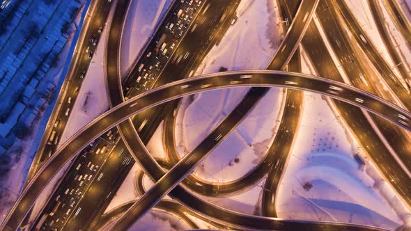 Illuminated Road Junction and Cars Traffic at Winter Evening. Flyover. Aerial View