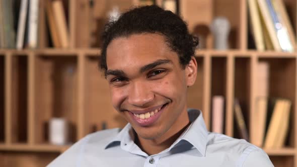 Headshot of Positive Male Employee in Formal Shirt Looking at the Camera and Smiling