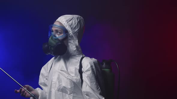 A Person in White Protective Medicine Suit Looking Around in Smoky Room with Cleaning Equipment and