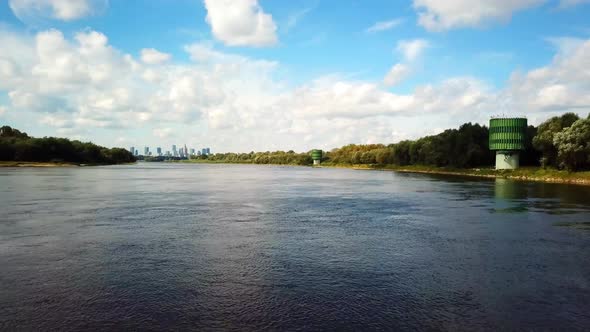 Aerial droneing over the river. Going towards city of Warsawr 4k