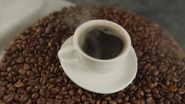 Cup of Coffee and Saucer on Coffee Beans