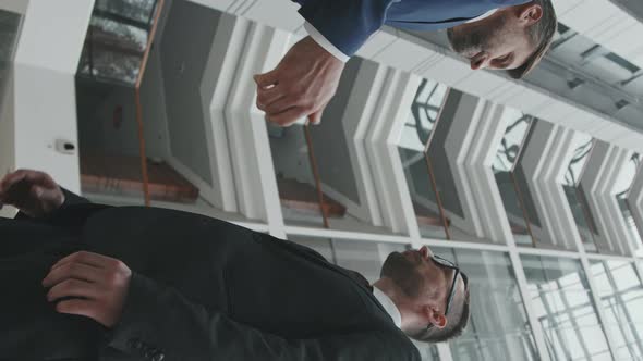Vertical Shot of Businessman Shaking Hand to his Lawyer
