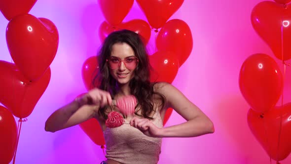 Joyful Woman with Heart Shaped Balls Dancing