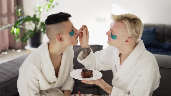 Domestic Homosexual Couple Feeding Each Other with Cake