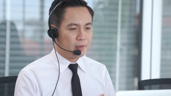 Businessman Wearing Headset Working Actively in Office