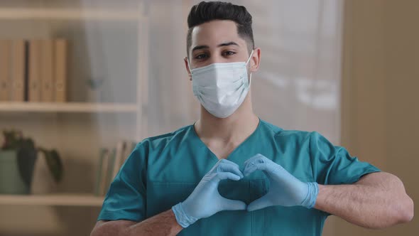 Portrait Man Young Arabian Doctor Nurse Wear Face Mask Medical Uniform Showing at Camera Heart Love