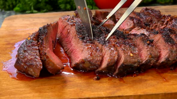 The Chef Checks the Quality of the Juicy Steak on a Wooden Board