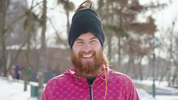 Bearded Athlete Laughing at Camera in Winter Park