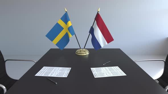 Flags of Sweden and the Netherlands and Papers