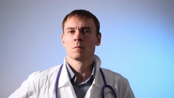 Male Doctor Putting on Stethoscope and Medical Mask
