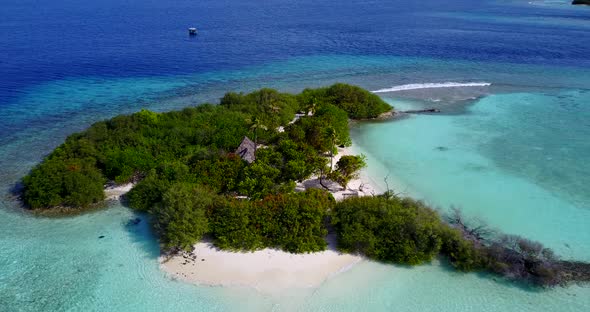 Tropical birds eye island view of a sunshine white sandy paradise beach and aqua turquoise water bac