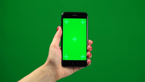 Female Hand Holding the Newest Smartphone on Green Screen